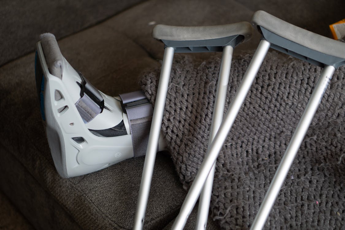 close-up of foot in walking brace and crutches