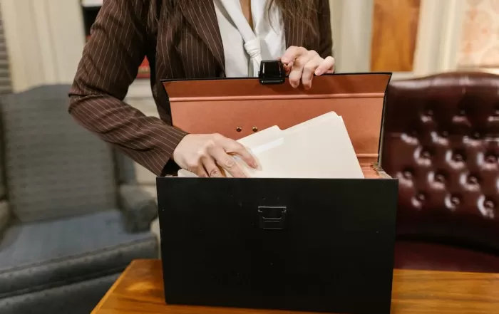 personal injury lawyer reaching for documents in briefcase